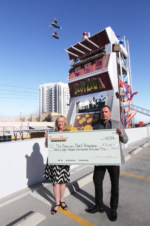 Charity Challenge Results in Record-Breaking Donation to American Heart Assn. 1 Fremont Street Experience’s Chief Marketing Officer, Paul McGuire, presents an outrageously large check to Debbie Smith, American Heart Association Executive Director.