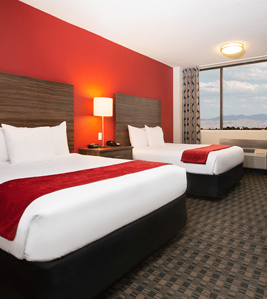 Two queen beds inside a hotel room at The D.
