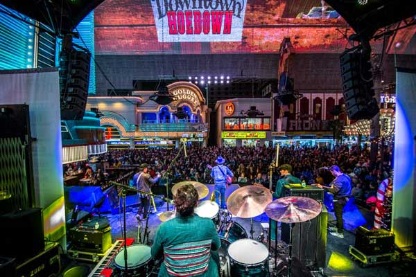 A band playing on stage at the Fremont Street Experience. 